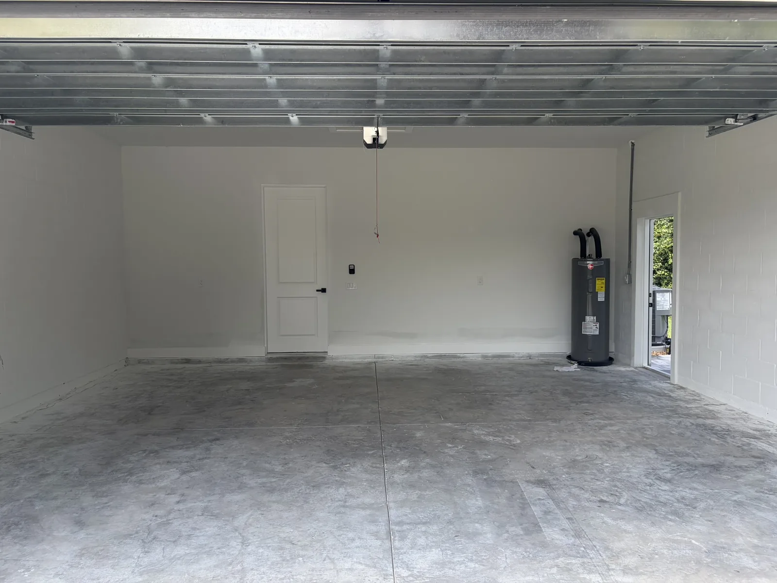 Bare unfinished garage floor before epoxy installation