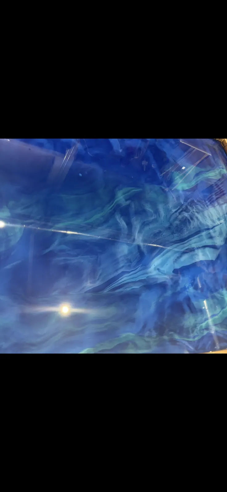 Ocean blue metallic epoxy floor with flowing teal movement